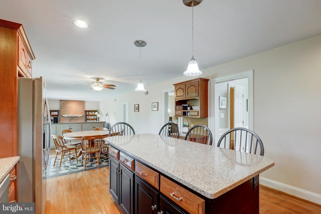 2912 Weaver Rd, Lancaster, PA 17601 - kitchen with appliances with stainless steel finishes, light wood-style floors, decorative light fixtures, a ceiling fan, and light stone countertops