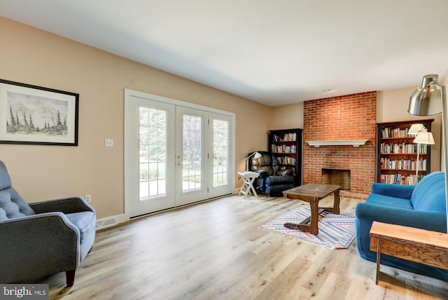 2912 Weaver Rd, Lancaster, PA 17601 - living room featuring wood finished floors, a fireplace, and french doors