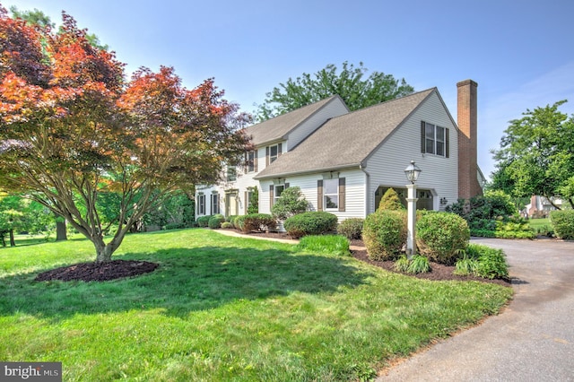 2912 Weaver Rd, Lancaster, PA 17601 - view of front of property featuring a chimney, a front lawn, roof with shingles, and asphalt driveway