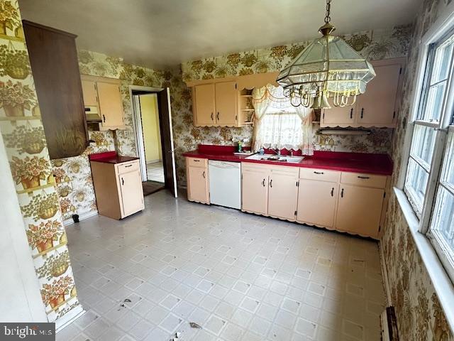 2304 Front Royal Pike, Winchester, VA 22602 - kitchen with dishwasher, wallpapered walls, a chandelier, dark countertops, and under cabinet range hood