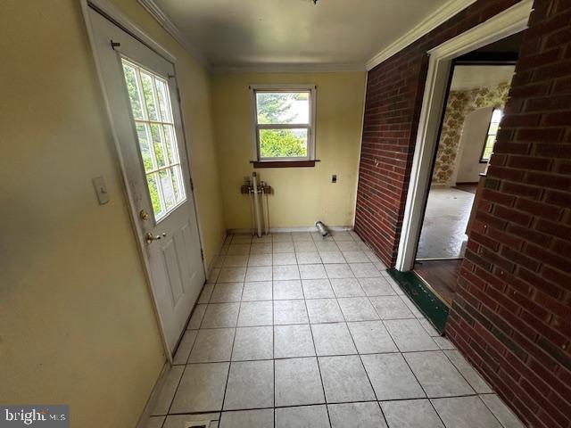 2304 Front Royal Pike, Winchester, VA 22602 - doorway to outside with brick wall, light tile patterned flooring, and ornamental molding