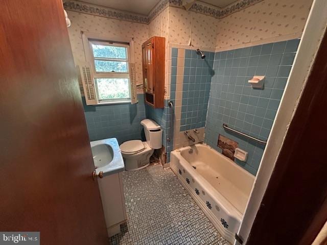 2304 Front Royal Pike, Winchester, VA 22602 - full bathroom featuring vanity, wallpapered walls,  shower combination, tile patterned flooring, and tile walls
