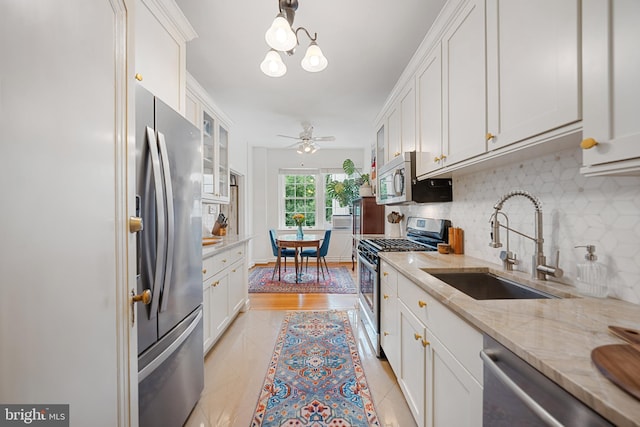 2737 Devonshire Pl NW Unit 321, Washington, DC 20008 - kitchen with stainless steel appliances, tasteful backsplash, white cabinets, and glass insert cabinets