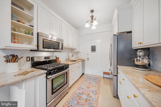 2737 Devonshire Pl NW Unit 321, Washington, DC 20008 - kitchen with appliances with stainless steel finishes, white cabinetry, decorative backsplash, and light stone counters
