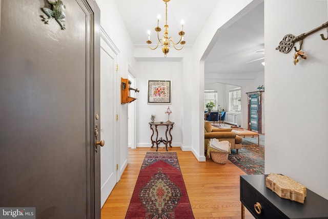 2737 Devonshire Pl NW Unit 321, Washington, DC 20008 - foyer featuring arched walkways, light wood finished floors, and a chandelier