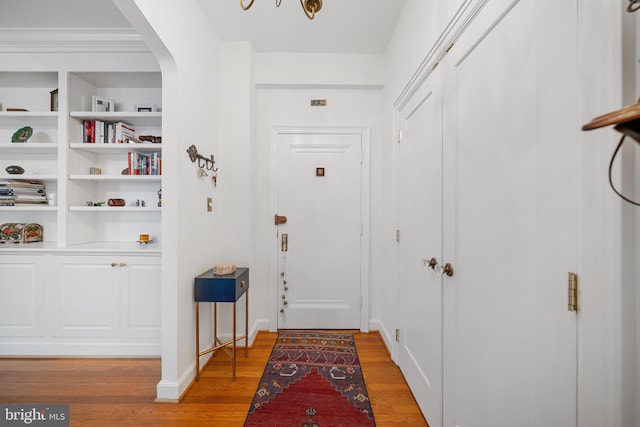 2737 Devonshire Pl NW Unit 321, Washington, DC 20008 - hallway with light wood-style floors, arched walkways, and built in shelves