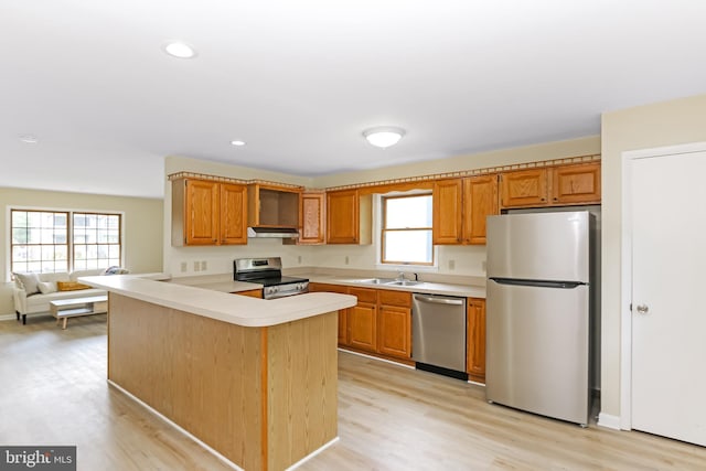 4421 Eastwinds, Chincoteague Island, VA 23336 - kitchen with stainless steel appliances, under cabinet range hood, light countertops, light wood-style flooring, and recessed lighting