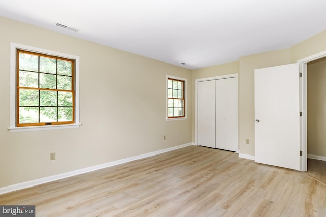 4421 Eastwinds, Chincoteague Island, VA 23336 - unfurnished bedroom with light wood-style flooring and a closet