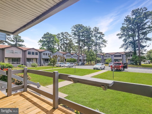 4421 Eastwinds, Chincoteague Island, VA 23336 - wooden terrace featuring a residential view and a yard