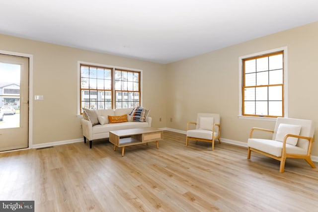 4421 Eastwinds, Chincoteague Island, VA 23336 - living area with light wood-style flooring and plenty of natural light