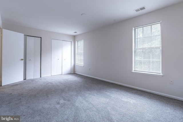 12803 Climbing Ivy Dr, Germantown, MD 20874 - unfurnished bedroom featuring multiple closets and carpet floors