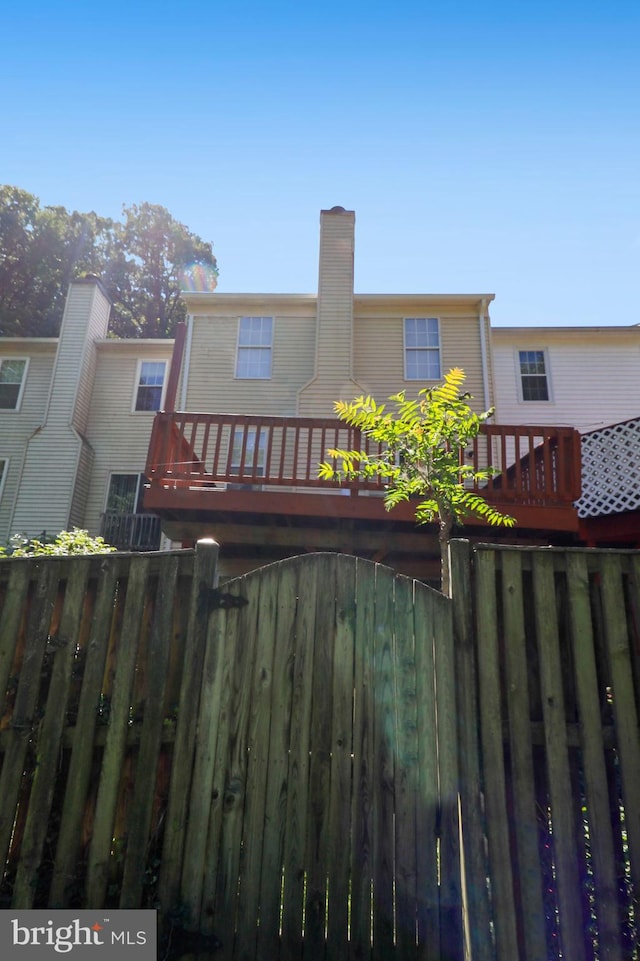 12803 Climbing Ivy Dr, Germantown, MD 20874 - rear view of property featuring a balcony and a chimney