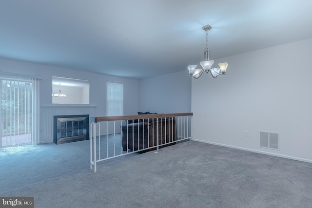 12803 Climbing Ivy Dr, Germantown, MD 20874 - empty room featuring a chandelier, carpet flooring, and a glass covered fireplace