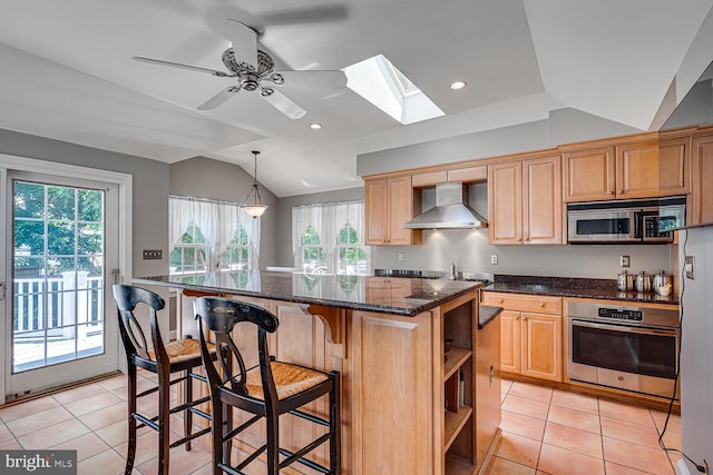 2413 Taylor Ave, Alexandria, VA 22302 - kitchen featuring wall chimney range hood, appliances with stainless steel finishes, lofted ceiling, a skylight, and healthy amount of natural light