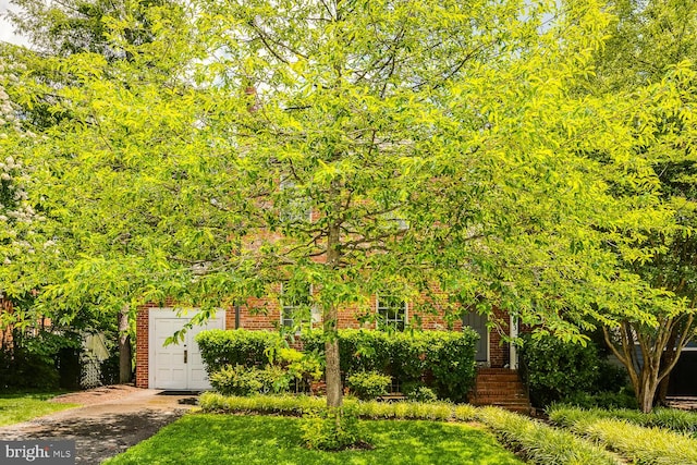 2413 Taylor Ave, Alexandria, VA 22302 - obstructed view of property with brick siding, driveway, and a garage