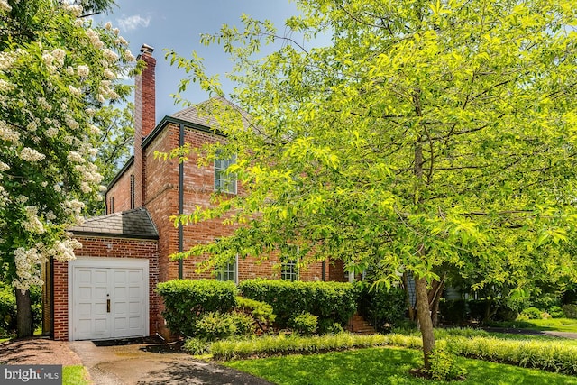 2413 Taylor Ave, Alexandria, VA 22302 - view of property exterior with brick siding, a chimney, and a garage