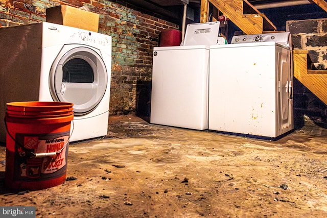 1504 Stricker, Druid, MD 21217 - laundry area featuring separate washer and dryer and brick wall