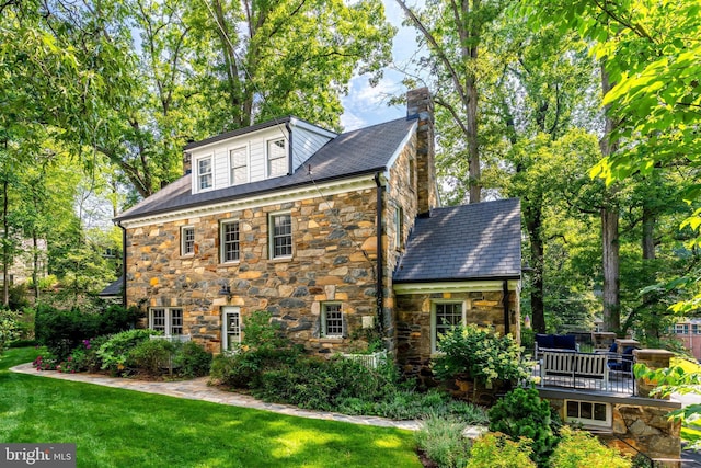 3666 Military Rd, Arlington, VA 22207 - view of property exterior featuring stone siding, a chimney, and a yard