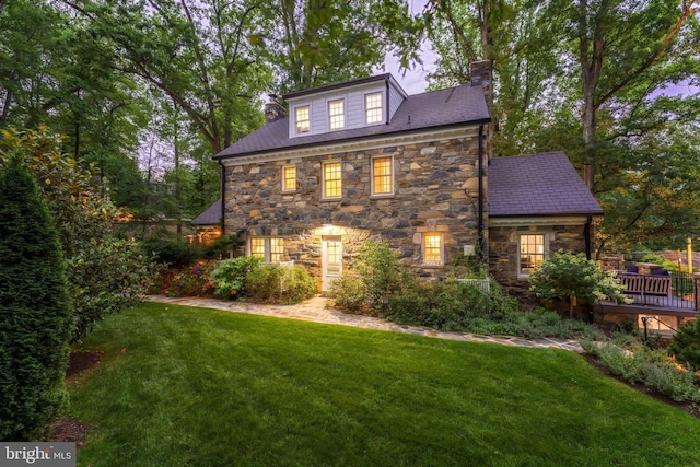3666 Military Rd, Arlington, VA 22207 - view of property exterior featuring stone siding, a chimney, a lawn, and a deck