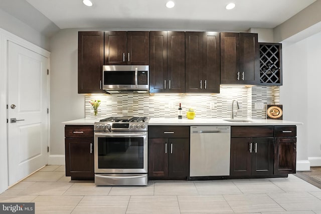 3831 Fulton St NW, Washington, DC 20007 - kitchen with stainless steel appliances, light countertops, backsplash, recessed lighting, and dark brown cabinets
