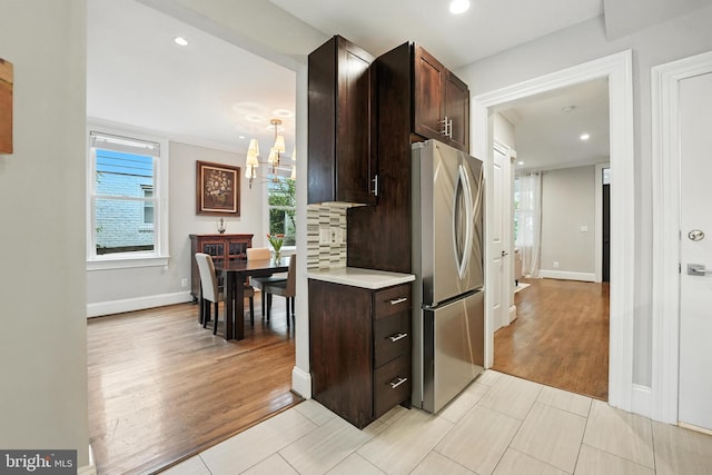 3831 Fulton St NW, Washington, DC 20007 - kitchen featuring freestanding refrigerator, a chandelier, dark brown cabinets, light countertops, and recessed lighting
