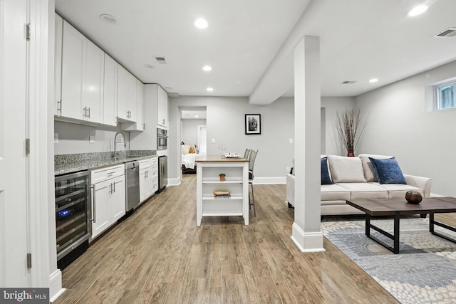 3831 Fulton St NW, Washington, DC 20007 - kitchen with beverage cooler, recessed lighting, white cabinetry, stainless steel dishwasher, and light wood finished floors