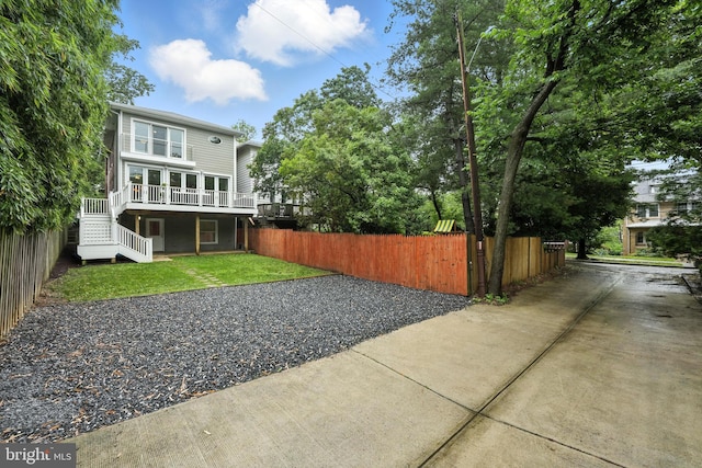 3831 Fulton St NW, Washington, DC 20007 - rear view of house with stairs, a wooden deck, and driveway