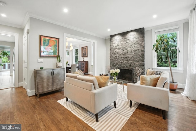 3831 Fulton St NW, Washington, DC 20007 - living area featuring healthy amount of natural light, a stone fireplace, crown molding, wood finished floors, and recessed lighting
