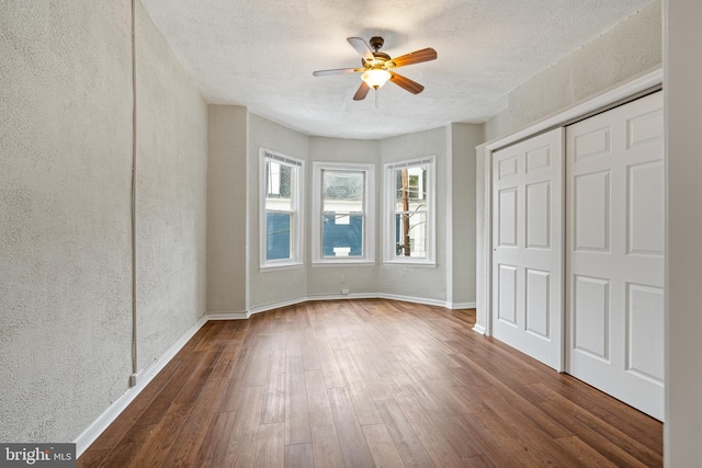 6539 Berdan St, Philadelphia, PA 19119 - unfurnished bedroom with dark wood-style floors, a textured wall, a closet, a textured ceiling, and ceiling fan
