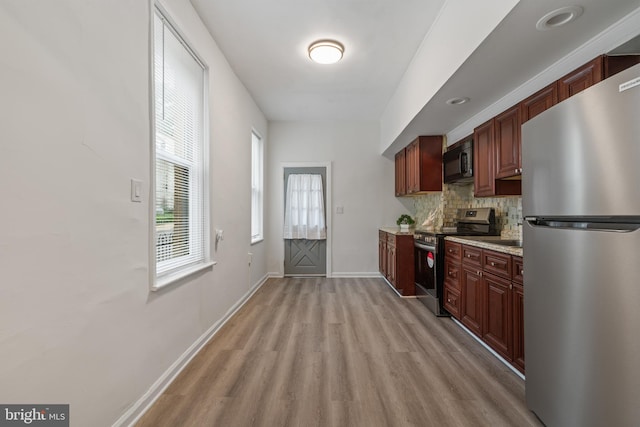 6539 Berdan St, Philadelphia, PA 19119 - kitchen with appliances with stainless steel finishes, light wood finished floors, backsplash, and light countertops