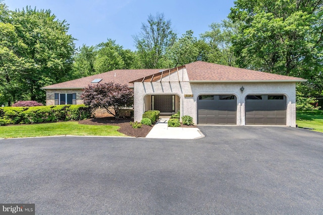 2381 Greensward S, Warrington, PA 18976 - view of front of property featuring an attached garage, driveway, stucco siding, and a shingled roof