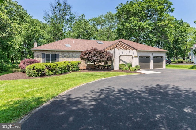 2381 Greensward S, Warrington, PA 18976 - view of front of home featuring an attached garage, a front yard, a chimney, asphalt driveway, and roof with shingles