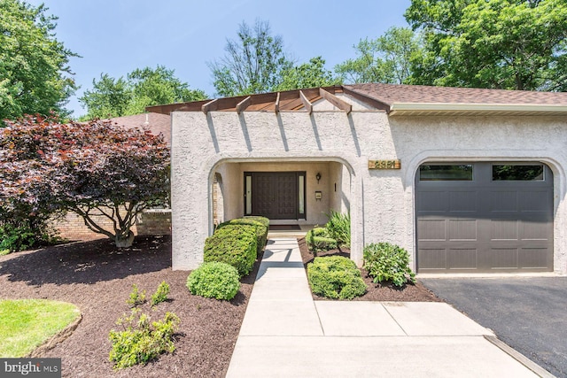 2381 Greensward S, Warrington, PA 18976 - view of front facade featuring an attached garage, stucco siding, driveway, and roof with shingles