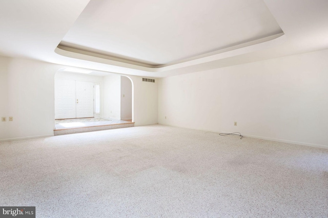2381 Greensward S, Warrington, PA 18976 - unfurnished room featuring a raised ceiling, arched walkways, and carpet flooring
