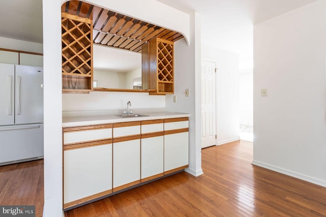 2381 Greensward S, Warrington, PA 18976 - kitchen featuring freestanding refrigerator, hardwood / wood-style floors, light countertops, and white cabinetry