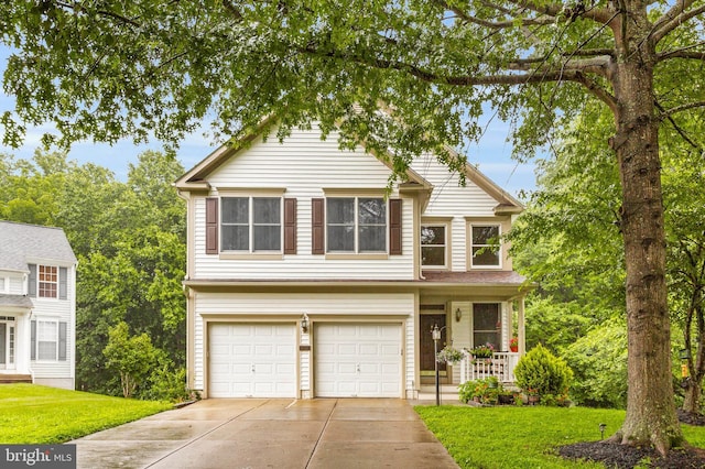 12177 Flowing Water Trl, Clarksville, MD 21029 - traditional-style house with a garage, concrete driveway, a front yard, and covered porch