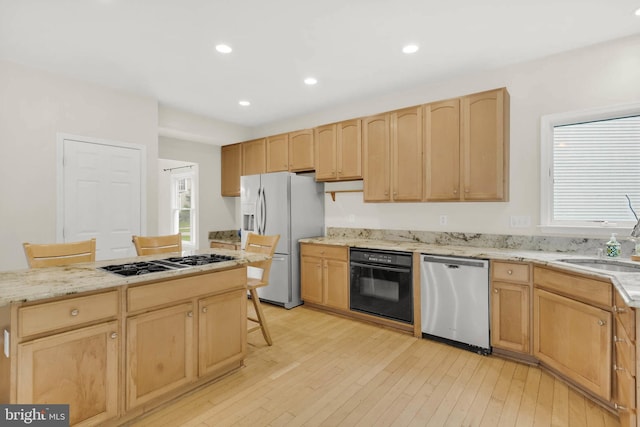 12177 Flowing Water Trl, Clarksville, MD 21029 - kitchen featuring stainless steel dishwasher, oven, fridge with ice dispenser, light brown cabinetry, and gas cooktop