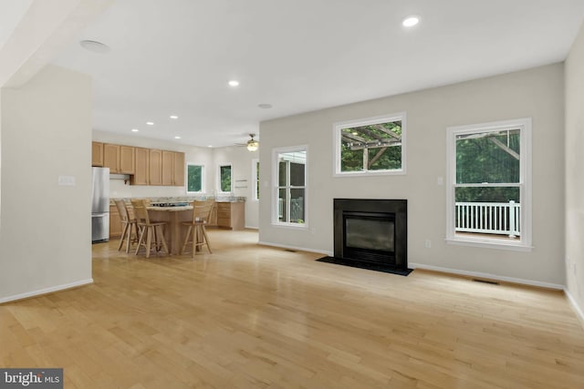 12177 Flowing Water Trl, Clarksville, MD 21029 - living room featuring a fireplace with flush hearth, recessed lighting, healthy amount of natural light, and light wood-style floors
