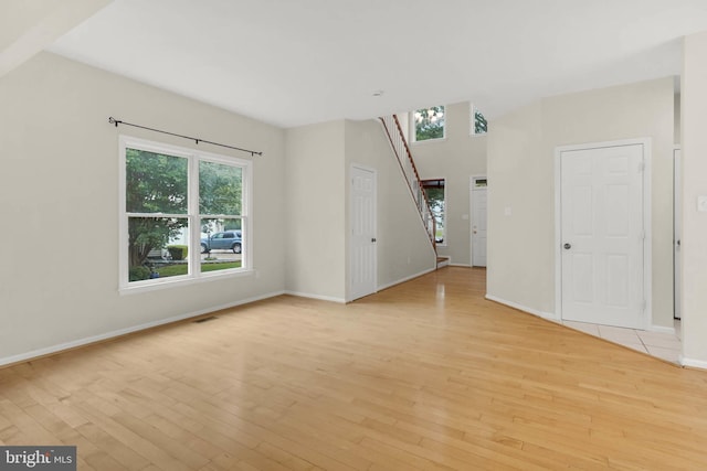 12177 Flowing Water Trl, Clarksville, MD 21029 - unfurnished living room with light wood finished floors and baseboards