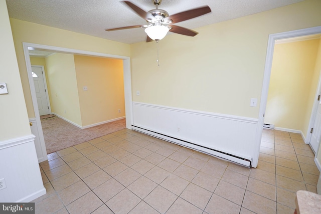 120 Ridgefield Ln, Fruitland, MD 21826 - spare room featuring a baseboard heating unit, a ceiling fan, light tile patterned flooring, and a textured ceiling