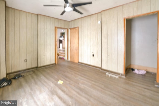 319 1st St, Slatington, PA 18080 - unfurnished bedroom featuring wood finished floors, wood walls, and ceiling fan