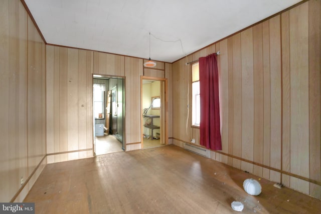 319 1st St, Slatington, PA 18080 - spare room with baseboard heating, wood finished floors, and wood walls