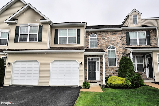 65 Emily Ct, Reading, PA 19606 - townhome / multi-family property featuring stone siding, driveway, and an attached garage