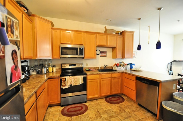 65 Emily Ct, Reading, PA 19606 - kitchen with appliances with stainless steel finishes, a peninsula, pendant lighting, light stone counters, and stone finish floors