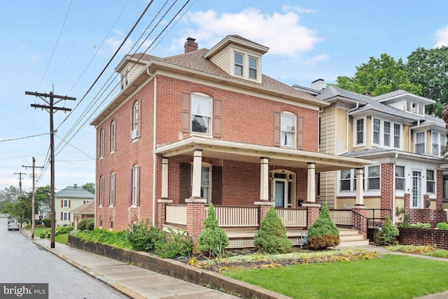 31 4th St, Hanover, PA 17331 - traditional style home featuring brick siding, covered porch, a chimney, and a front yard