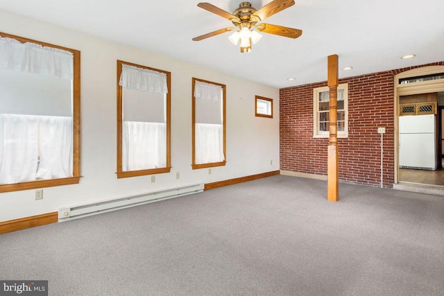 31 4th St, Hanover, PA 17331 - unfurnished living room with baseboard heating, carpet flooring, brick wall, and a ceiling fan