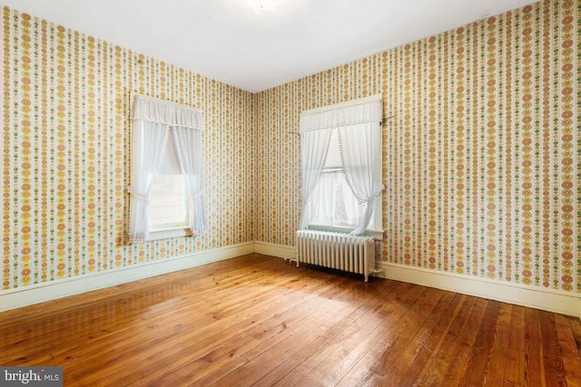 31 4th St, Hanover, PA 17331 - unfurnished room featuring radiator heating unit, hardwood / wood-style flooring, and wallpapered walls