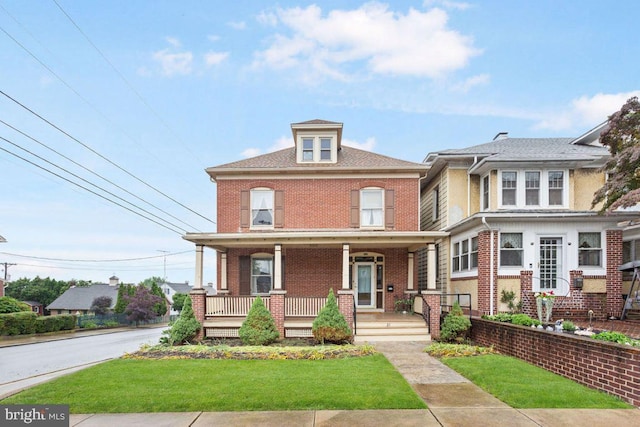 31 4th St, Hanover, PA 17331 - traditional style home with brick siding, a front yard, and a porch