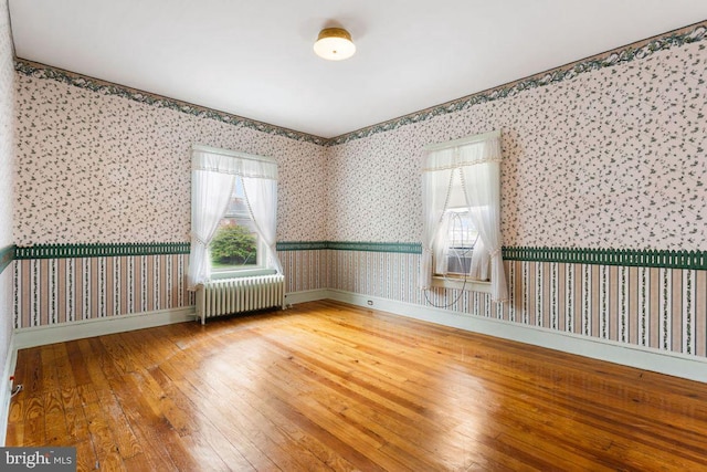 31 4th St, Hanover, PA 17331 - unfurnished room with radiator, wallpapered walls, and hardwood / wood-style floors