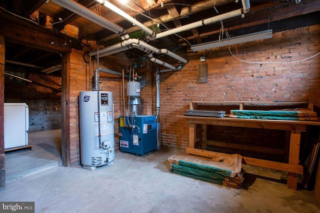 31 4th St, Hanover, PA 17331 - unfinished basement featuring gas water heater, a heating unit, washer / clothes dryer, and brick wall
